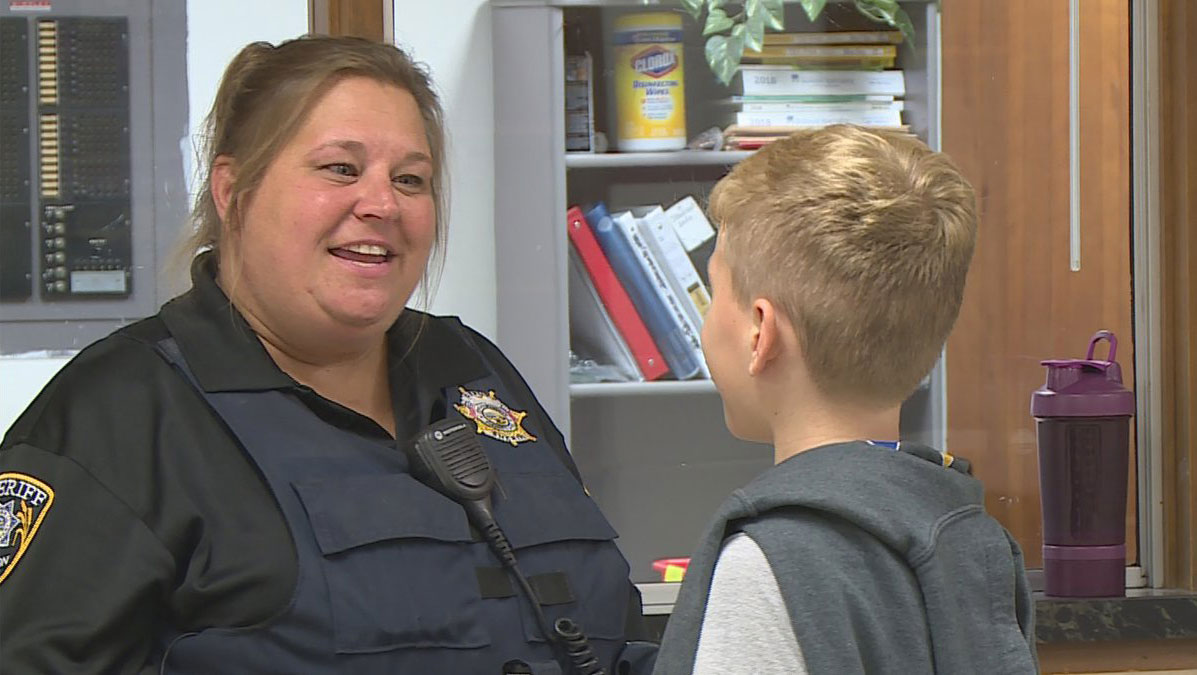 Photo of School Resource Officer interacting with a student.